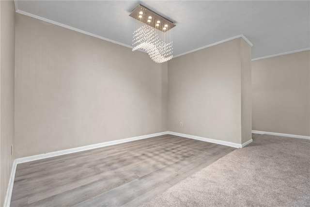 empty room with a notable chandelier and ornamental molding