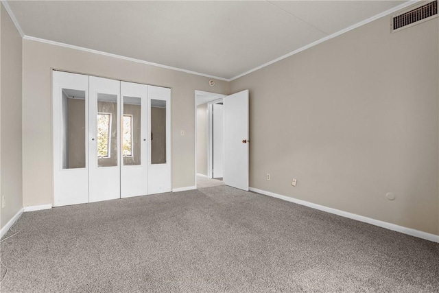 unfurnished bedroom featuring carpet flooring and crown molding