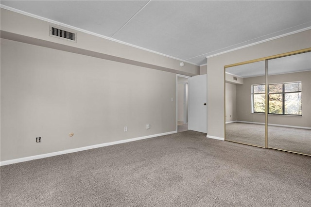 unfurnished bedroom featuring carpet, a closet, and ornamental molding