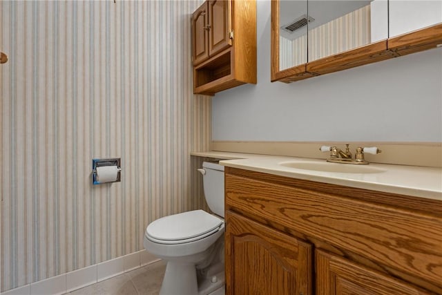 bathroom featuring toilet, vanity, and tile patterned floors