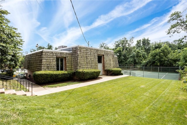 exterior space featuring a yard and tennis court