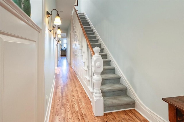 staircase with wood-type flooring