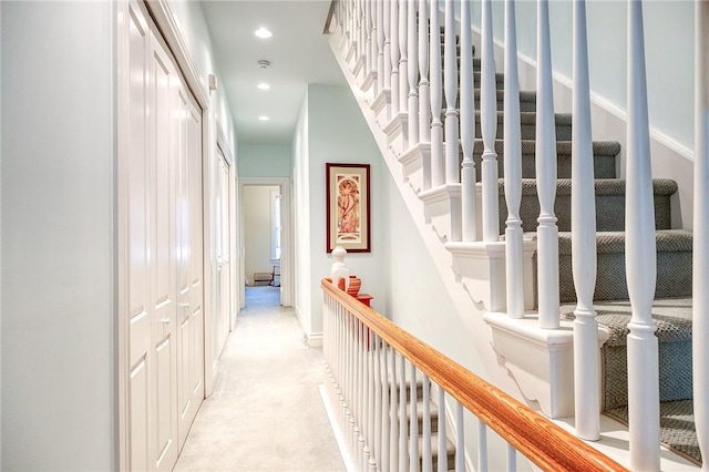 hallway featuring light carpet