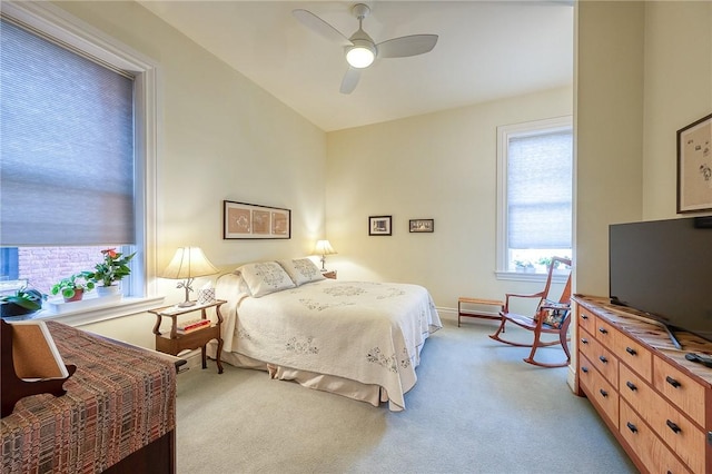 bedroom featuring light carpet and ceiling fan