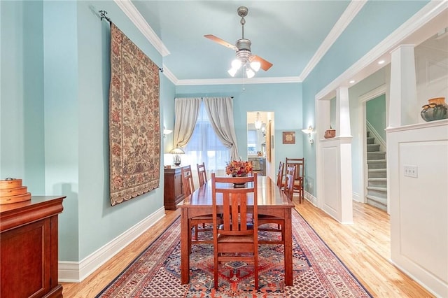 dining room featuring ceiling fan, light wood-type flooring, and crown molding