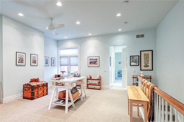 carpeted home office featuring ceiling fan