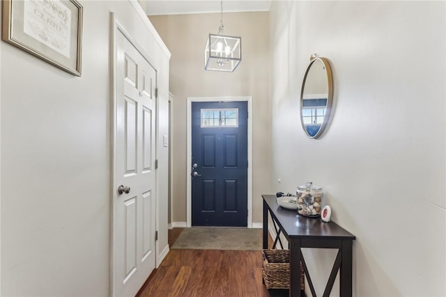 entrance foyer featuring an inviting chandelier and dark wood-type flooring