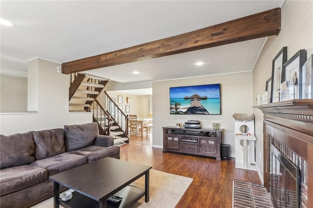 living room with a fireplace, beam ceiling, and dark hardwood / wood-style floors