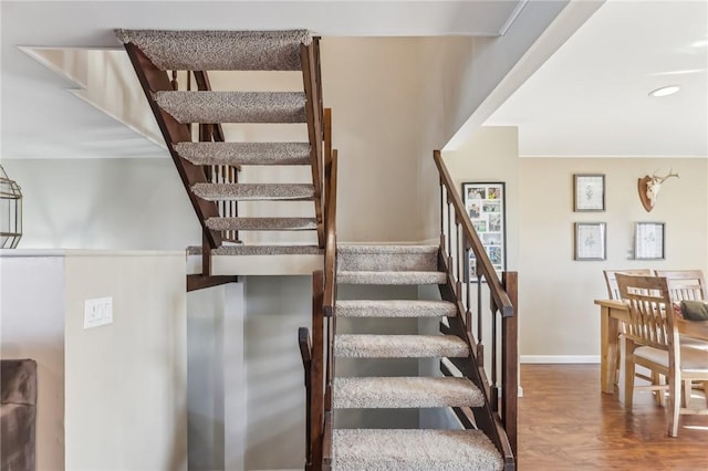 stairway with hardwood / wood-style flooring