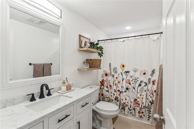 bathroom featuring vanity, a shower with shower curtain, and toilet