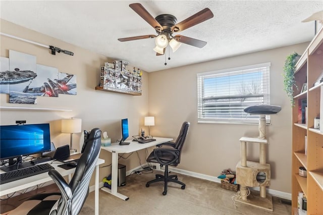 carpeted office featuring ceiling fan and a textured ceiling