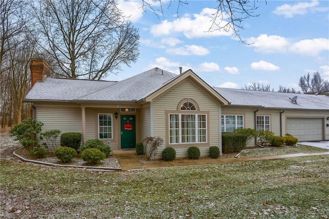 ranch-style home featuring a front yard and a garage