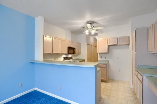 kitchen with ceiling fan, range, and kitchen peninsula