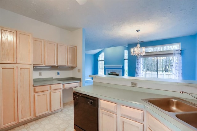 kitchen featuring light brown cabinets, sink, black dishwasher, decorative light fixtures, and a chandelier