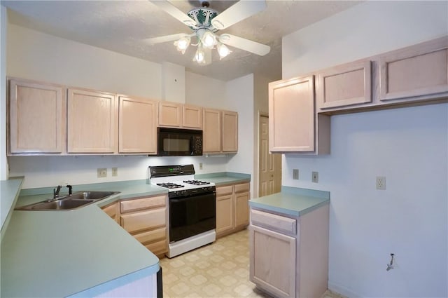 kitchen featuring light brown cabinets, white gas range oven, ceiling fan, and sink