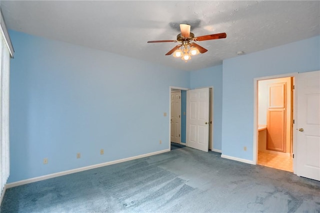 unfurnished bedroom with ceiling fan and carpet