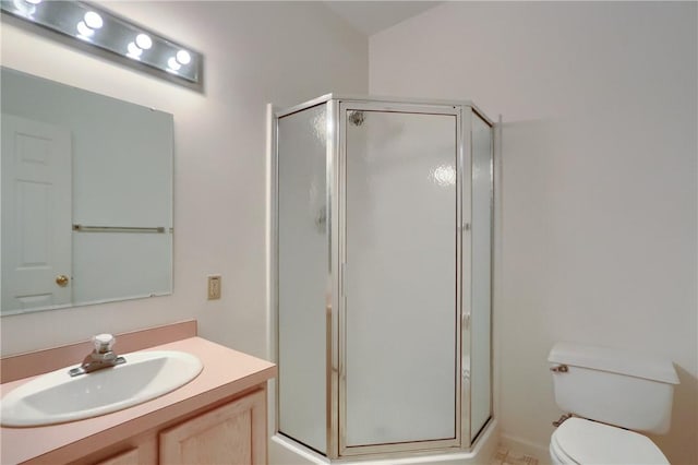 bathroom featuring toilet, an enclosed shower, and vanity