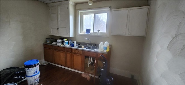 kitchen featuring dark wood-type flooring and sink