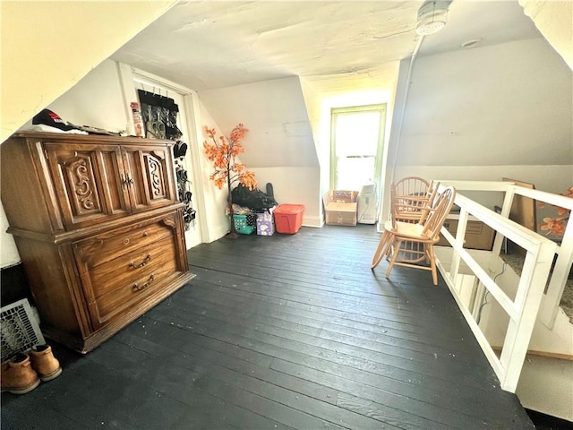 bonus room with dark hardwood / wood-style flooring and vaulted ceiling