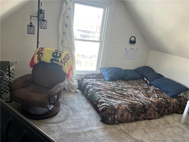 carpeted bedroom with lofted ceiling