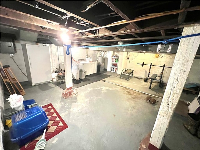 basement with white refrigerator and separate washer and dryer