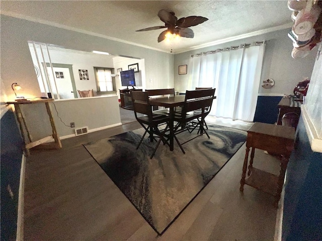 dining room featuring wood-type flooring, plenty of natural light, ceiling fan, and crown molding