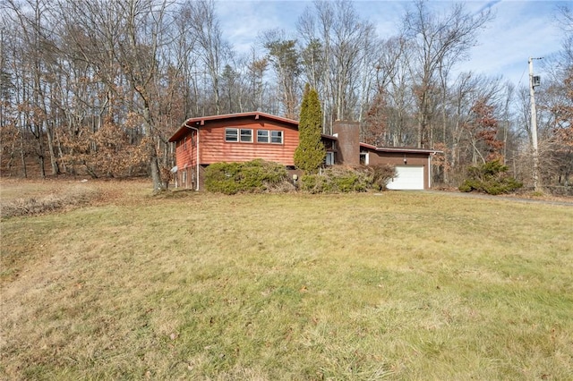 view of front of home with a garage and a front yard