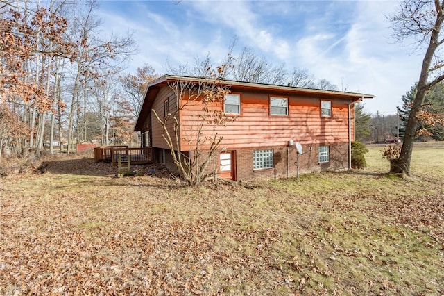 rear view of property featuring a wooden deck