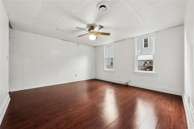 unfurnished room featuring ceiling fan and dark wood-type flooring