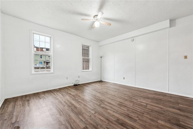 empty room featuring ceiling fan and hardwood / wood-style flooring