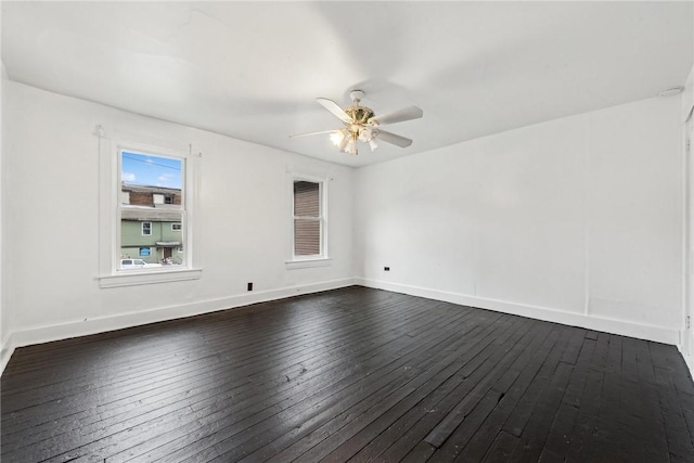 spare room featuring ceiling fan and dark wood-type flooring