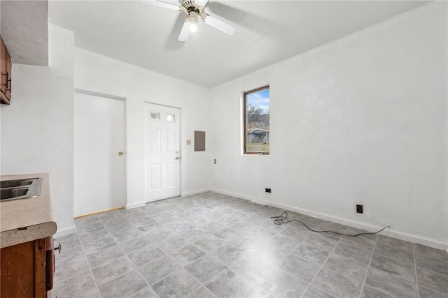 empty room featuring electric panel and ceiling fan