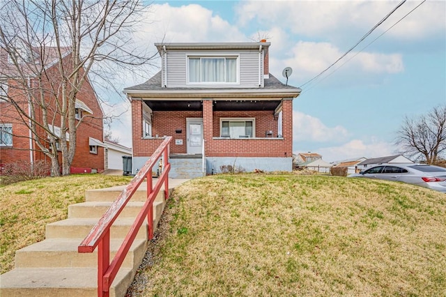 view of front of property with a porch and a front yard