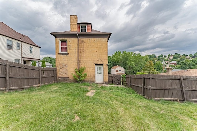 back of house with a lawn