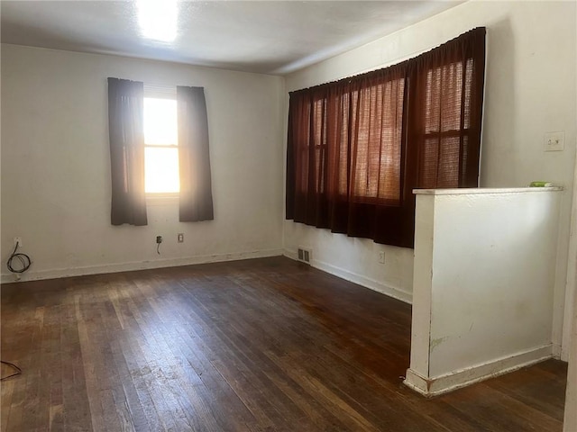 spare room with dark hardwood / wood-style floors