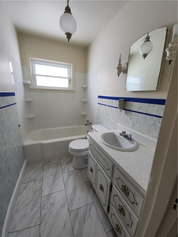 full bathroom with shower / bathing tub combination, vanity, toilet, and tile walls