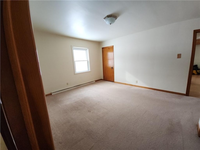 carpeted empty room with a baseboard radiator