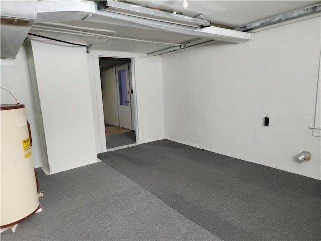 basement with dark colored carpet and gas water heater