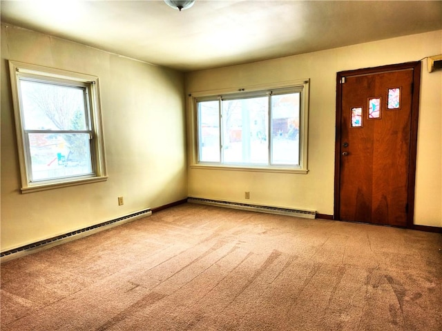 carpeted foyer with baseboard heating