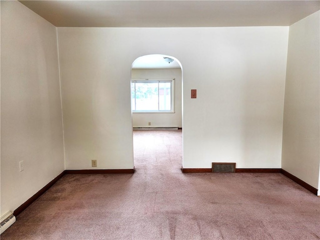 carpeted spare room with a baseboard radiator