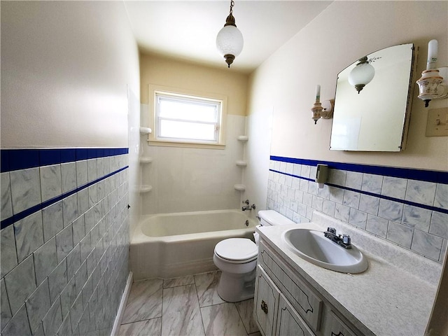 full bathroom featuring vanity, toilet, tile walls, and shower / washtub combination