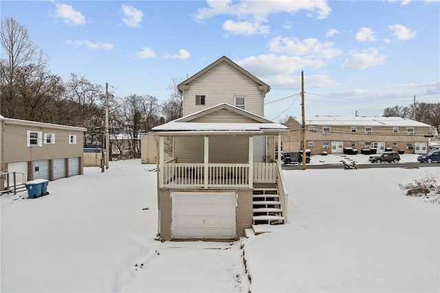 snow covered property with a porch