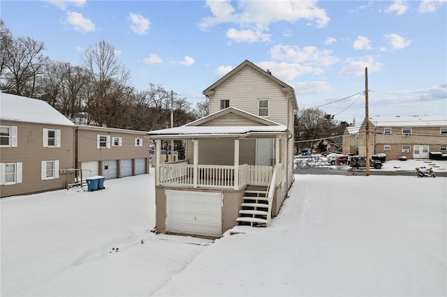 snow covered property with a porch