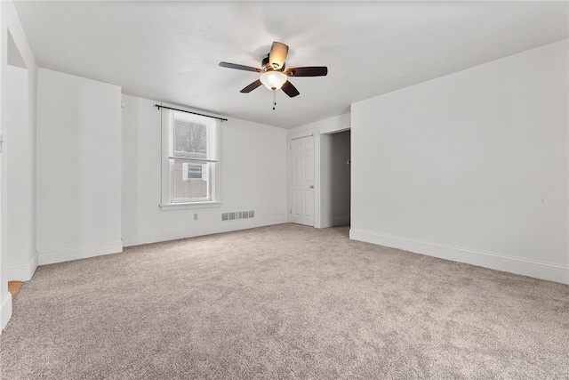 empty room with carpet flooring and ceiling fan