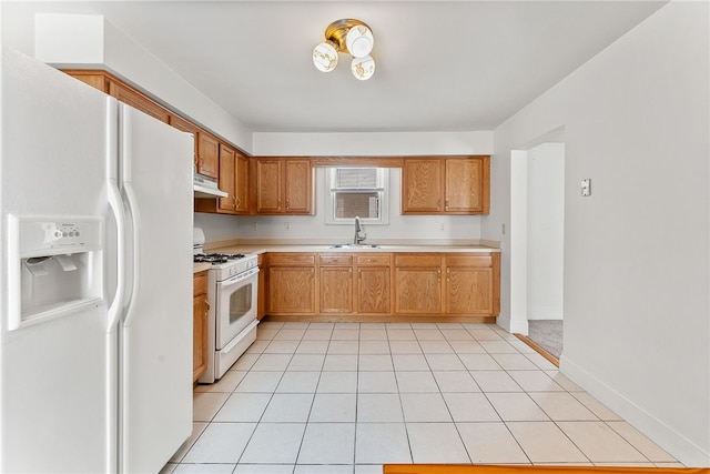 kitchen with light tile patterned floors, white appliances, and sink