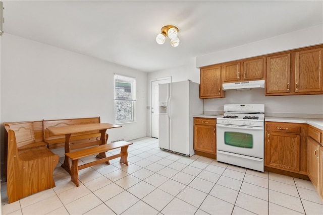 kitchen featuring light tile patterned floors and white appliances