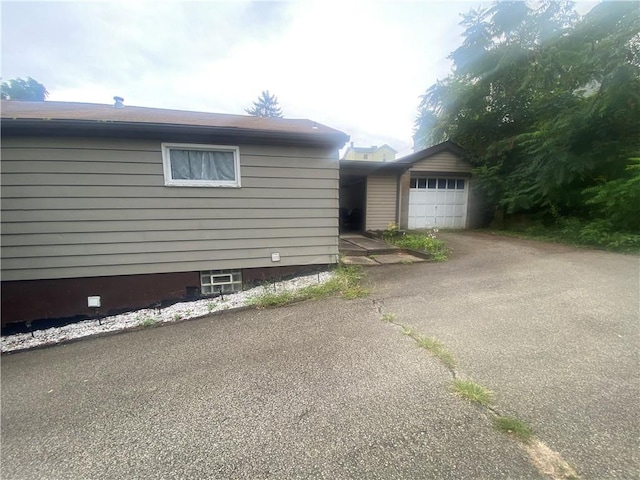 view of side of home featuring a garage