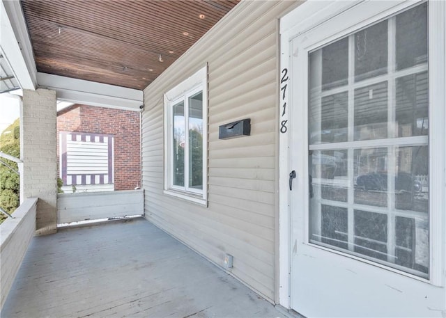 view of exterior entry with covered porch