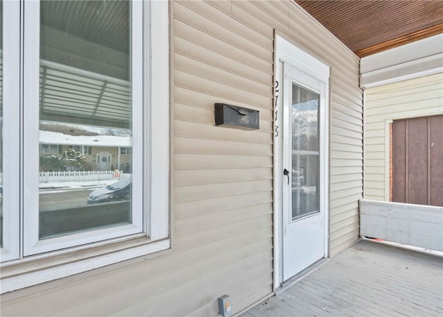 view of exterior entry with covered porch