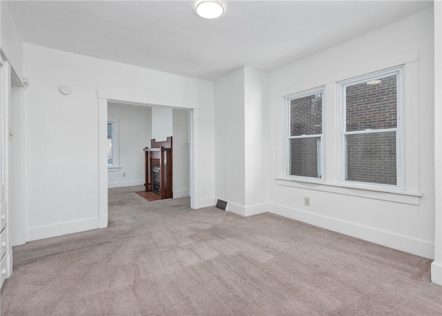 unfurnished room with light colored carpet